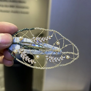 Handmade woven oval hair clip with dark green beads and faux pearls for a graceful look