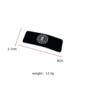 Detail of a 8cm black velvet hair clip with a vintage blue-grey rhinestone embellishment