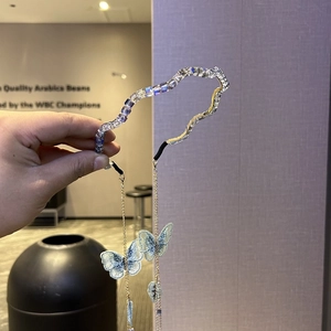 Handheld crystal wave headband featuring blue embroidery butterflies and gold tassels