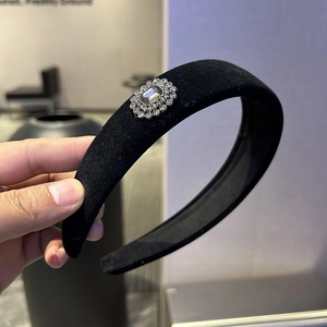Elegant black velvet padded headband with crystal rhinestone gemstone centerpiece