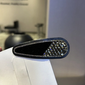Detail of vintage teardrop snap clip with velvet texture and glittering rhinestones