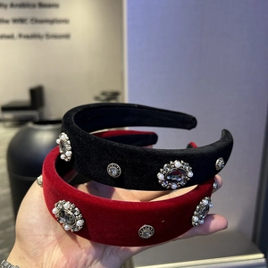 Detail of velvet headbands with vintage metal buckles, shiny rhinestones and pearls