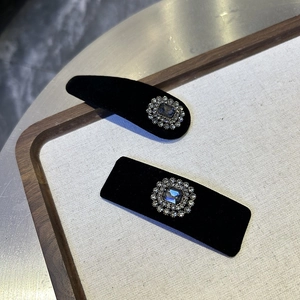 Elegant black velvet hair clip set with vintage gemstones and sparkling rhinestones