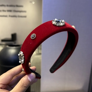 Detail of red velvet padded headband with vintage flower crystals and faux pearls
