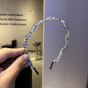Detailed macro of crystal headband featuring lavender stones on a silver wavy metal frame
