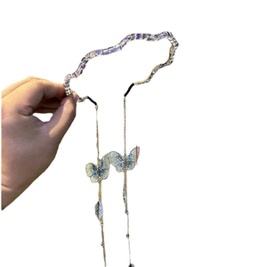Elegant wavy rhinestone headband with blue butterfly charms and long metal tassels