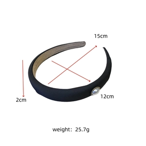 Detail view of black satin pearl headband with dimensions 15cm x 12cm and 2cm width