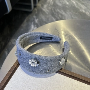 Close-up of handmade wide grey felt headband featuring silver sequin flowers and rhinestones
