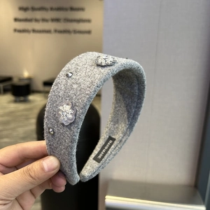 Detailed view of handmade grey wool headband with sparkling sequins and rhinestone flowers