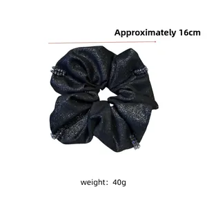 Detail of 16cm grey beaded scrunchie with glitter fabric and elegant sparkling finish