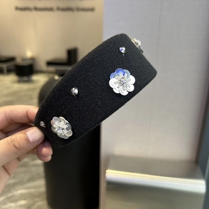 Luxurious black padded headband with sparkling silver sequin flowers and rhinestones
