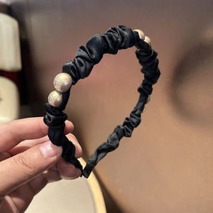 Elegant black pleated satin headband with champagne pearls in a chic French style