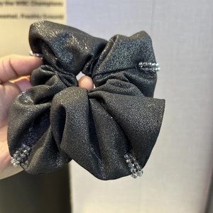 Detail of grey beaded hair scrunchie with metallic glitter fabric and crystal accents