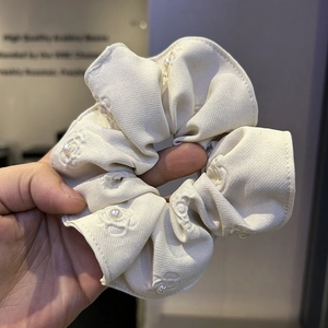 Embossed floral cream scrunchie with white pearl embellishments and jacquard texture