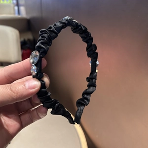 Elegant black pleated satin headband with crystal rhinestones for a high-volume hair look