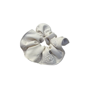 Elegant off-white satin scrunchie with camellia flower embroidery and pearl accents