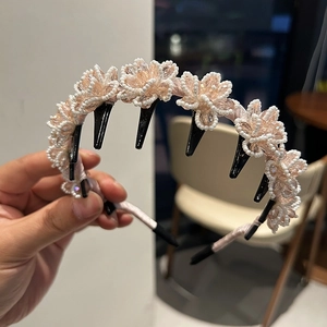 Close-up of handmade pink crystal flower headband with small black clips and white beads