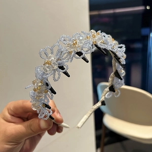 Detail of light blue beaded flower headband with transparent crystals and inner hair comb