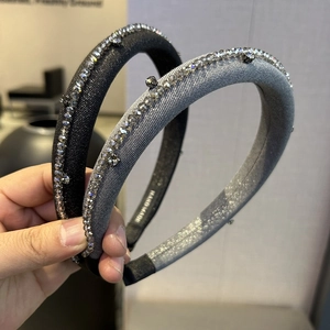 Detailed view of handmade padded headbands with sparkling grey rhinestones and satin finish