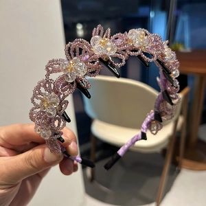 Detailed shot of handmade purple crystal flower headband with integrated hair clips