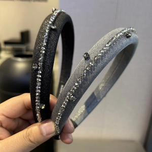 Detail of padded sponge headbands in black and grey with hand-sewn crystal beads