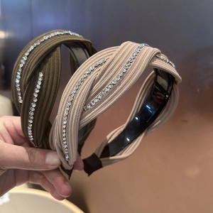 Detail showing knotted wide headbands with knit texture and rhinestone embellishments