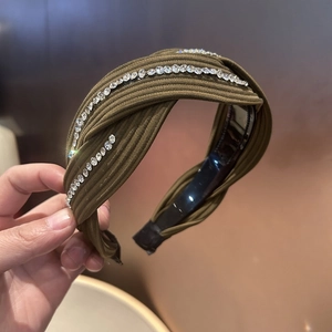 Luxe olive green padded headband with crisscross rhinestone accents and ribbed fabric texture