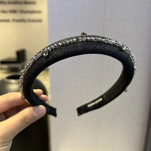 Close-up of handmade gray beaded headband with glossy fabric and thick sponge padding