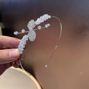 Détail macro du serre-tête argenté orné de papillons en zircon et de cristaux brillants