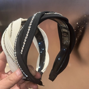 Close-up of knotted headband with sparkling rhinestones and anti-slip inner teeth