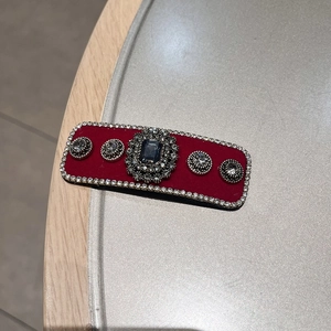 Detailed macro view of vintage flocking hair clip with red velvet and crystals