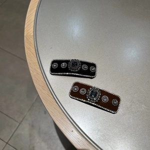 Detail view of vintage velvet hair clips in black and brown with rhinestone embellishments
