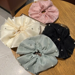 Detail of four-piece double-layer mesh scrunchies set with pearls and rhinestones
