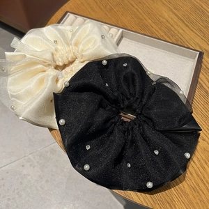 Detailed macro of double-layer mesh scrunchies with white pearls and small rhinestones