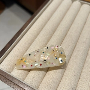 Minimalist acetate hair clip with colorful rhinestones in a marble white finish
