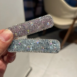 Close-up of luxury rhinestone square hairpins in purple and blue with silver crystal trim