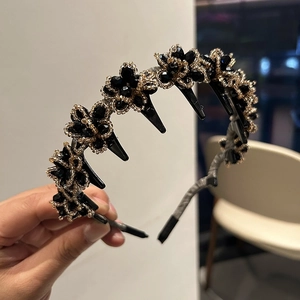Detail of beaded black flower headband with integrated hair clips for secure styling