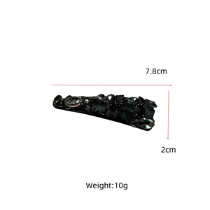 Detailed macro view of luxury rhinestone hair clip with love engraving and grey crystals