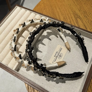 Detail of luxury crystal hairbands with faux pearls and spikes in a jewelry tray