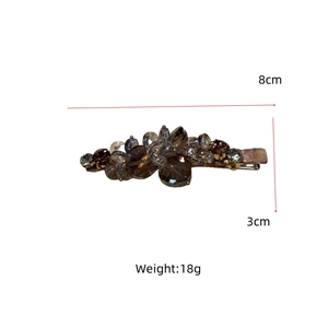 Detailed view of luxury crystal hair clip showing size of 8cm by 3cm and 18g weight