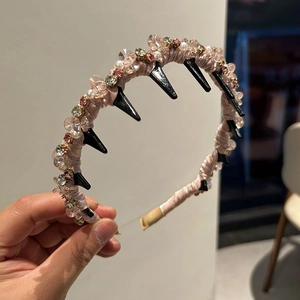 Detail showing hand-decorated headband with champagne crystals and non-slip comb teeth