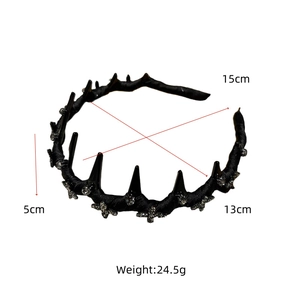 Detailed close-up of a French black velvet headband with spikes and rhinestone details
