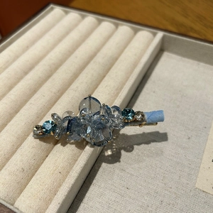 Elegant Korean style blue crystal hair clip with beads on a soft velvet jewelry display tray