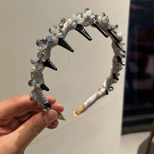Detailed shot of non-slip headband teeth with blue crystals and pearls decoration