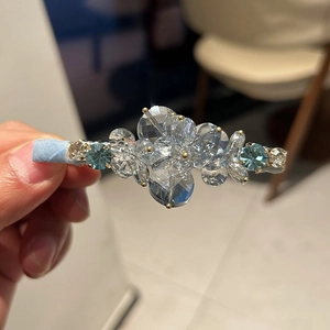 Detail of light blue and clear crystal hair clip with a layered duckbill clamp design