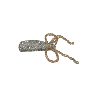 Elegant floral hair clip with white pearls and champagne crystal bow on silver base