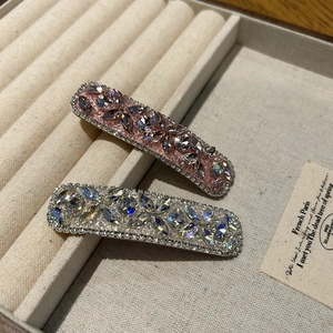 Detailed macro view of vintage luxury hair clips with pink and purple rhinestones