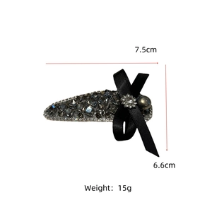 Detailed view of luxury bow hair clip with gray crystals and pearl showing dimensions