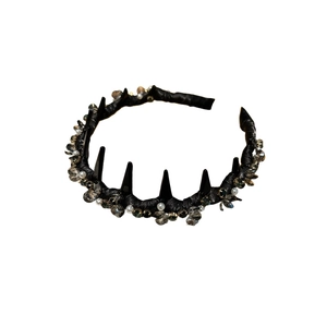 Gothic black headband with spikes, clear crystals and white pearls on white background