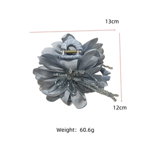 Detail view of large blue fabric floral hair claw with dimensions 13cm and weight 60.6g